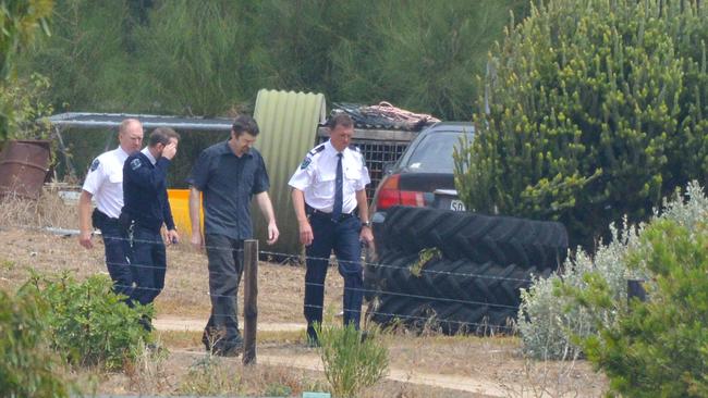 Accused Gene Bristow, centre, with sheriffs officers on his property in Meningie during a jury visit. Picture: AAP Image/Brenton Edwards