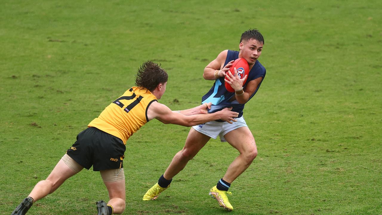 Tyson Gresham dodges a tackler. Picture: Chris Hyde/AFL Photos/via Getty Images