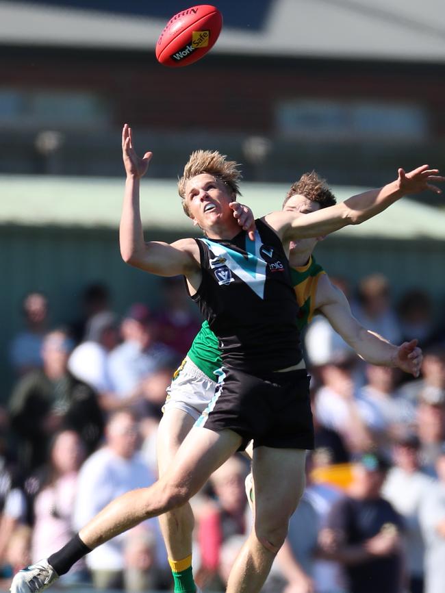 Wonthaggi’s Jack Hutchinson marks in front of Leongatha’s Jackson Harry in front of a big grand final crowd at Morwell. Picture: Yuri Kouzmin