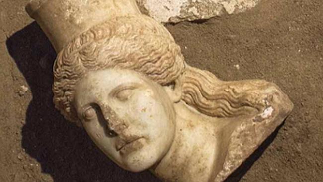 This picture provided by Greece's Culture Ministry, Oct. 20, 2014, shows the broken-off head of a marble sphinx, one of a pair that decorated the entrance of a large 4th century B.C. tomb under excavation at Amphipolis in northern Greece. Bones from a skeleton found in the tomb's innermost chamber could help solve the riddle of who was buried in opulent splendor there. A Culture Ministry statement on Wednesday, Nov. 12, 2014, said the skeleton was strewn in and around a rectangular stone-lined cist, under the floor of the cavernous, vaulted structure that is 8 metres (26 feet) tall. (AP Photo/Greek Culture Ministry)