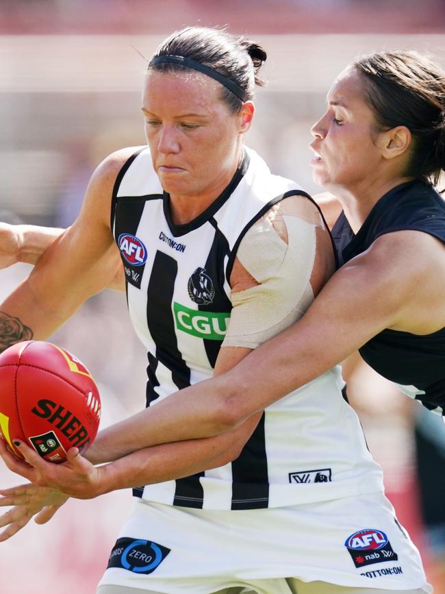 Collingwood defender Stacey Livingstone tries to bust through a tackle.