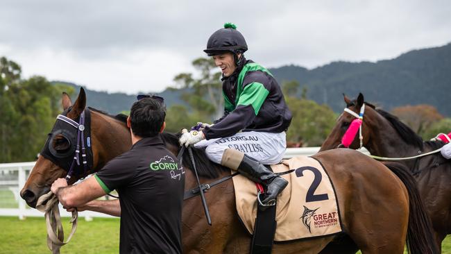 Corey Bayliss and Bullion Wolf greet trainer Leslie Gordy in the mounting yard after winning the 2021 Cairns Amateurs Cup at Cannon Park.