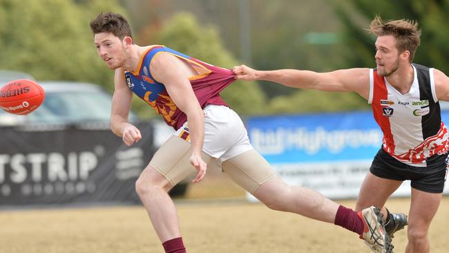 Nepean Football League: Devon Meadows v Tyabb at Glover Reserve, Devon Meadows. Tyabb #32 Liam Rogan under pressure from Devon Meadows #32 Locky Burke.  Picture: AAP/ Chris Eastman