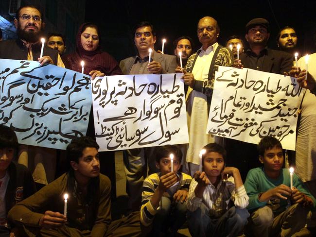 Members of a civil society group hold candles during a vigil for the victims of a plane crash, in Multan, Pakistan, Wednesday, Dec. 7, 2016. Picture: AP Photo/Muhammad Asim