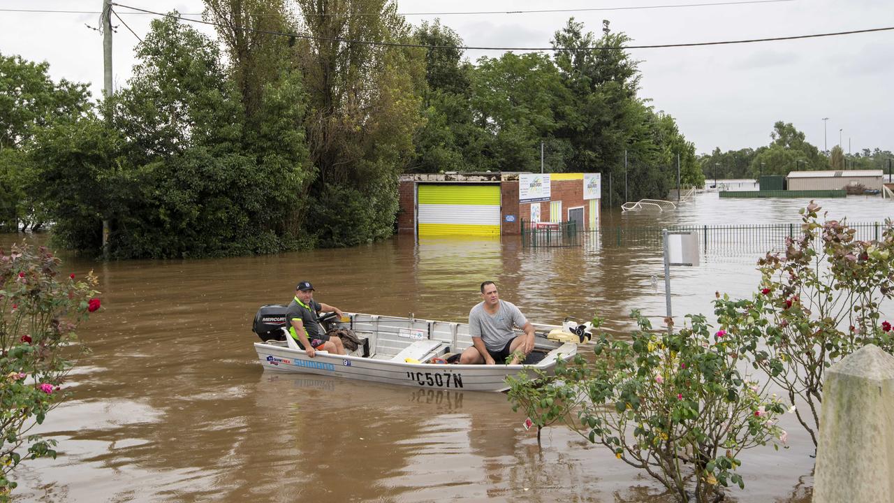 People pictured on a boat on Cawdor St in Camden. Picture / Monique Harmer