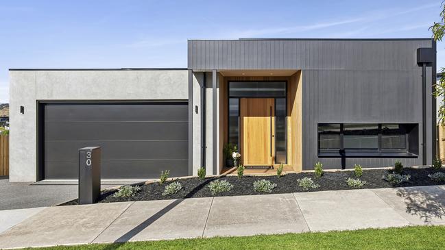 The four-bedroom, three-bathroom house has garaging for five cars.