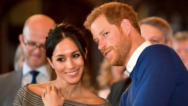 Prince Harry whispers to Meghan Markle as they watch a dance performance by Jukebox Collective during a visit to Cardiff Castle.