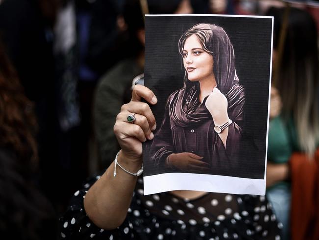 A protester holds a portrait of Mahsa Amini during a demonstration. Picture: AFP