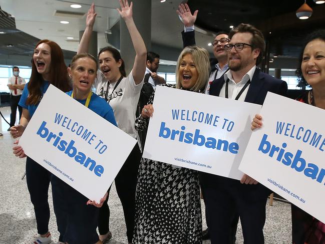 Airport staff greet the first passengers back from Sydney since the Queensland borders reopened on December 1, 2020 in Brisbane. Picture: Jono Searle/Getty Images