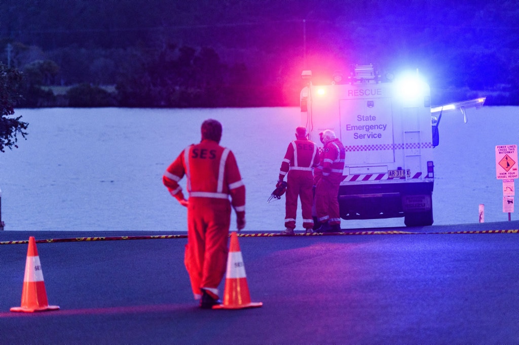 Emergency services workers wait at the scene where a car entered the river near the courthouse in Maclean. Picture: Adam Hourigan