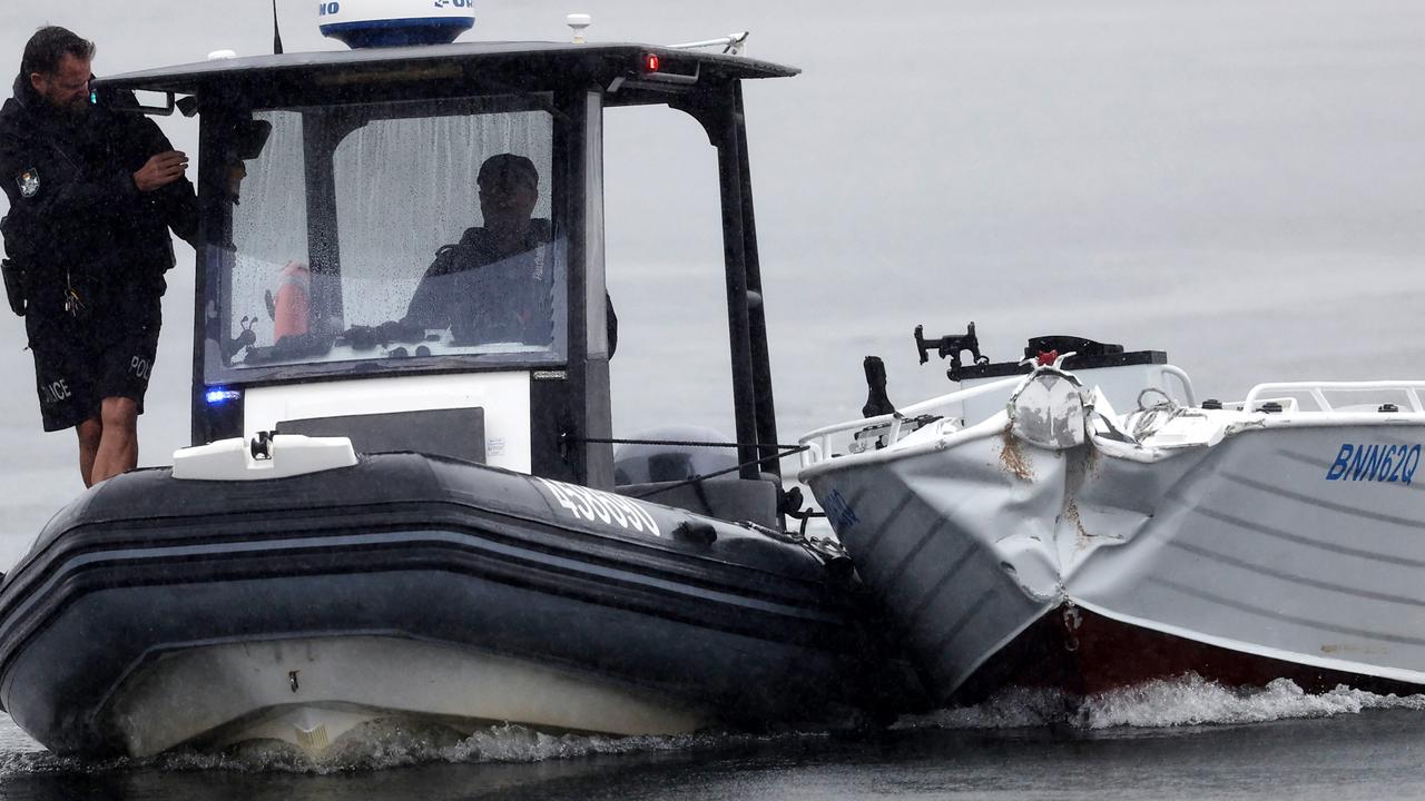 A damaged tinnie is towed to shore by police after an incident on the Gold Coast Broadwater on Friday morning. Picture: Nigel Hallett