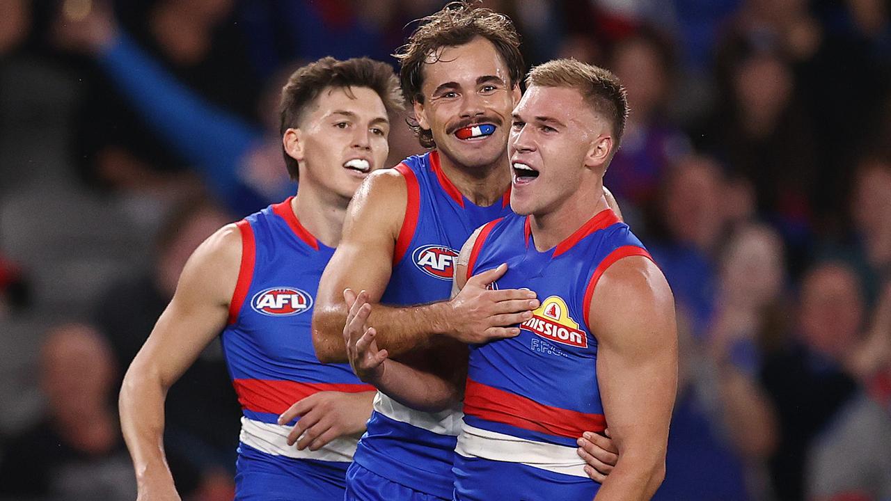 Bulldog Robbie McComb soaks up his first AFL goal.