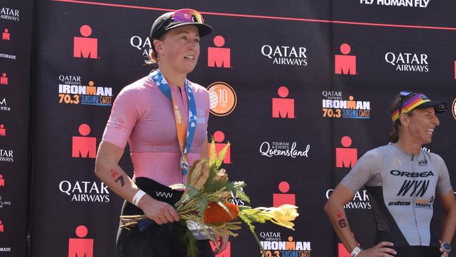 Women's third place: Sophie Perry on the podium at the Sunshine Coast Ironman 70.3 2023.