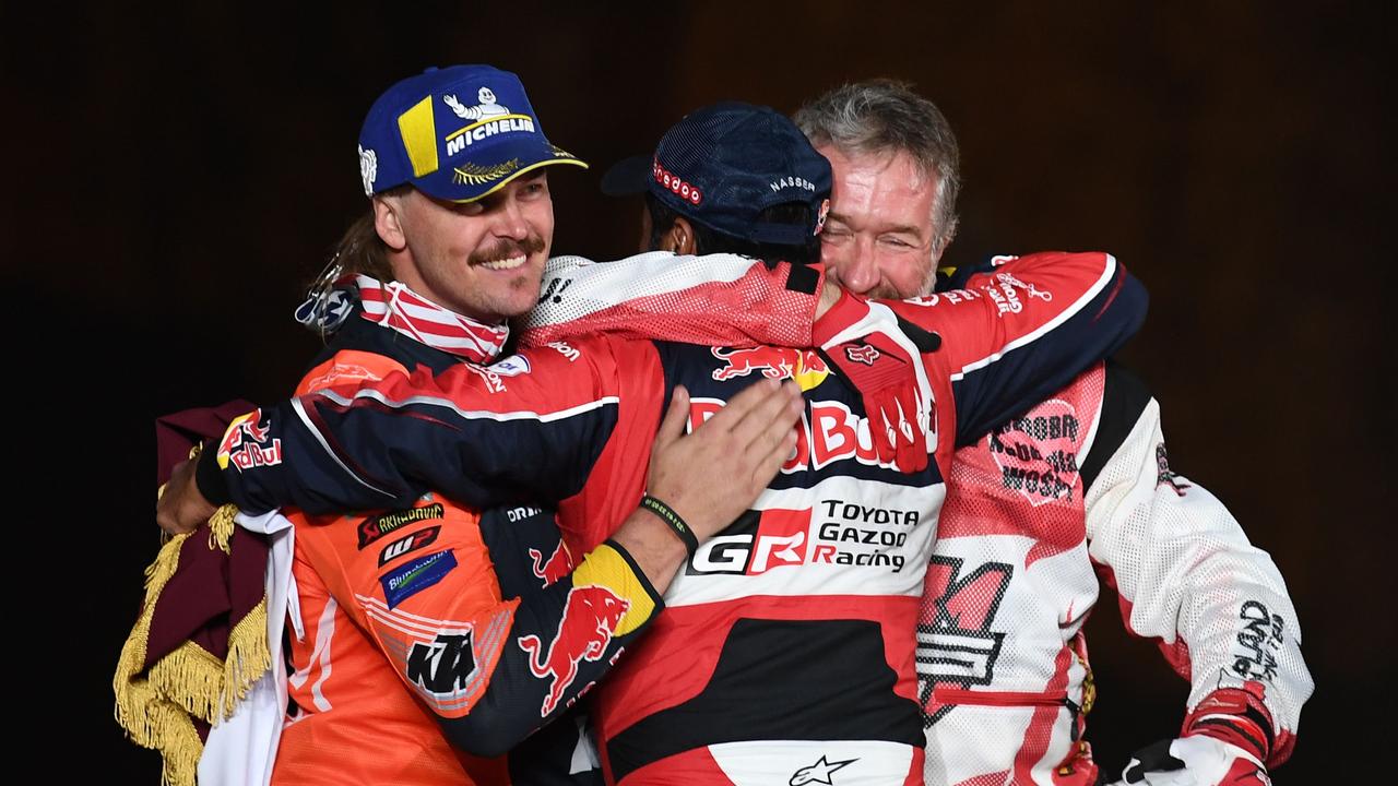 Toby Price (L) celebrates on the Dakar podium. (Photo by FRANCK FIFE / AFP)