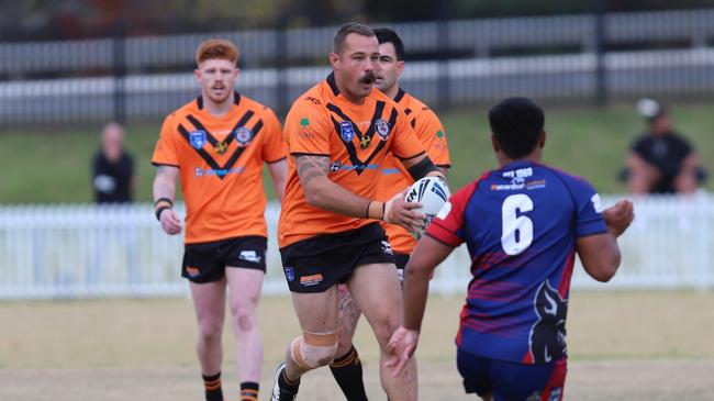 Big tash, bigger moves: Tony Campbell thunders forward for the Tigers. Picture: Steve Montgomery