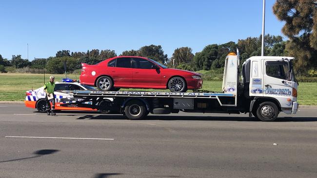 More than 10 police surrounded a man after an alleged police pursuit. Picture: Madeline Crittenden