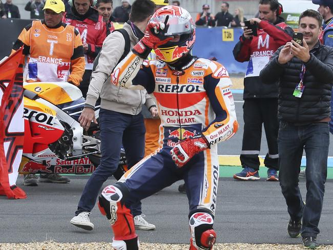 MotoGP rider Marc Marquez celebrates by the side of the track after winning the French Motorcycle Grand Prix.