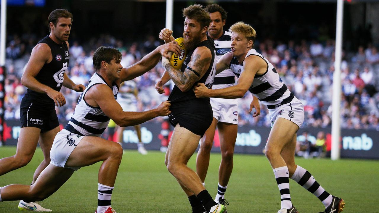 Zach Tuohy is tackled by Tom Hawkins (left) in a pre-season game in 2015. Picture: George Salpigtidis