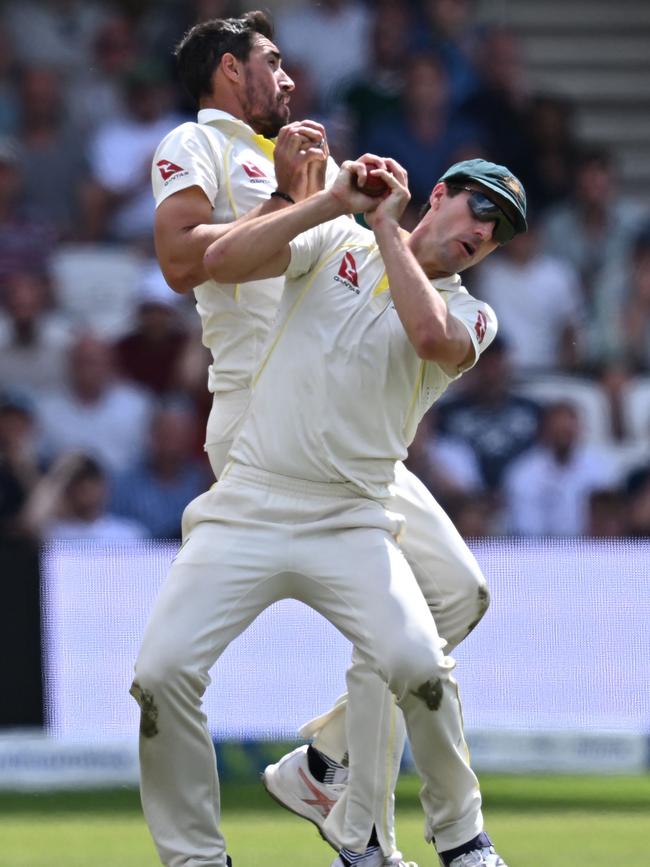 Mitchell Starc (L) closes in as Pat Cummins takes a catch to dismiss England's Harry Brook on day four of the third Ashes cricket Test match.