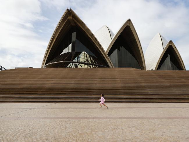 A lone child running in front of the Sydney Opera House yesterday. Picture: Richard Dobson