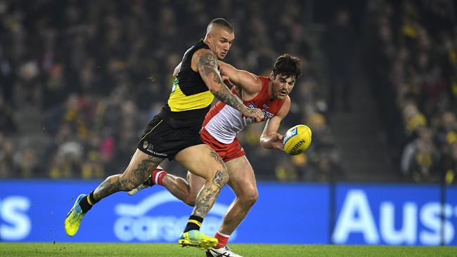 Dustin Martin and George Hewett fight for the ball at Etihad Stadium on Thursday night. Picture: AAP