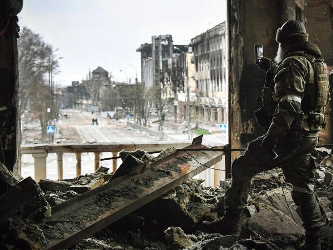 UKRAINE - RUSSIA CONFLICT 100 DAYS 100 PICTURES AFP presents a selection of 100 pictures to mark 100 days of Russia's war in Ukraine  A Russian soldier patrols at the Mariupol drama theatre, bombed last March 16, on April 12, 2022 in Mariupol, as Russian troops intensify a campaign to take the strategic port city, part of an anticipated massive onslaught across eastern Ukraine, while Russia's President makes a defiant case for the war on Russia's neighbour. - *EDITOR'S NOTE: This picture was taken during a trip organized by the Russian military.* (Photo by Alexander NEMENOV / AFP) / UKRAINE - RUSSIA CONFLICT 100 DAYS 100 PICTURES