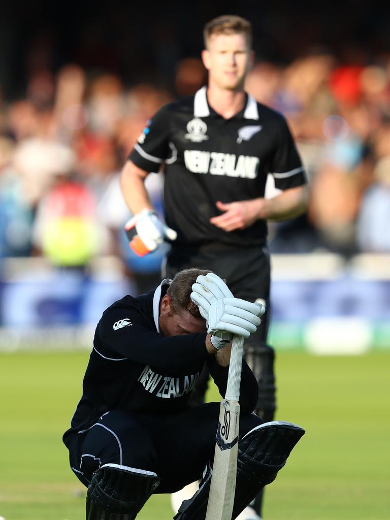 Jimmy Neesham moves toward distraught teammate Martin Guptill. (Photo by Michael Steele/Getty Images)