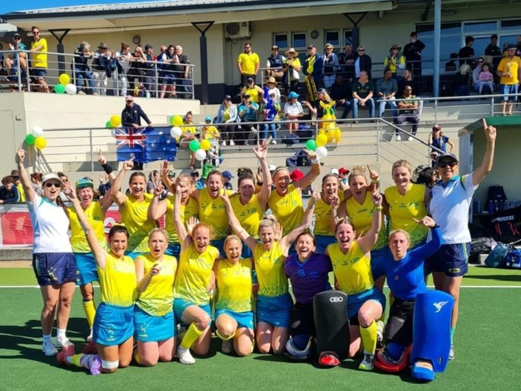 The Australian over-40 women's team celebrate after winning the Masters World Cup grand final.