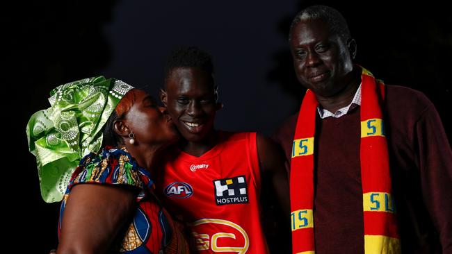 Gold Coast recruit Mac Andrew with proud parents Mary and Lual. Picture: Michael Willson/AFL Photos via Getty Images