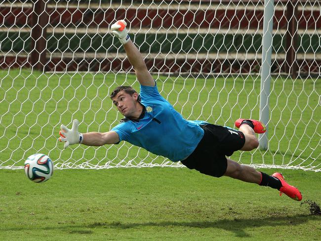 Mat Ryan dives for a ball during training before the World Cup. Picture: George Salpigtidis