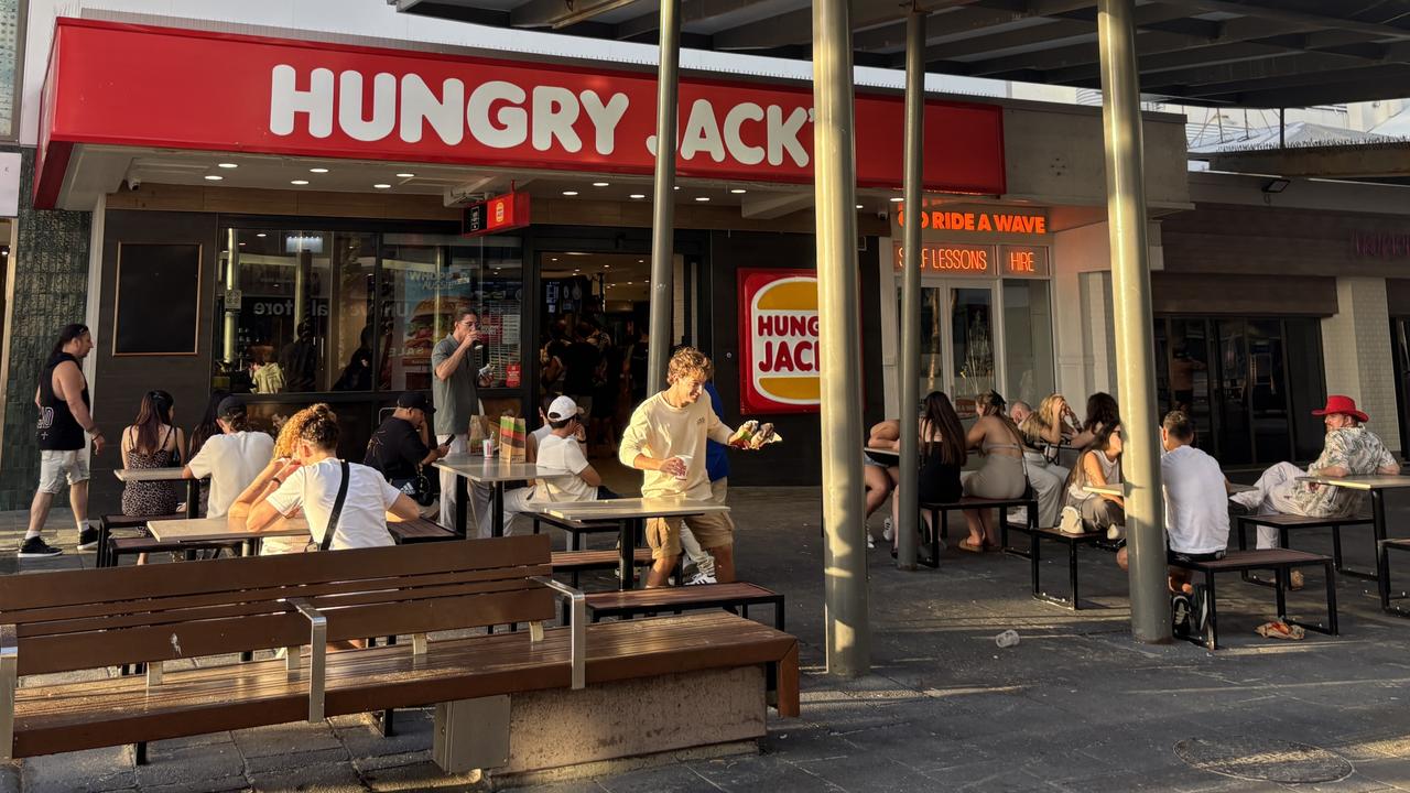 Revellers from the night before still up on New Year's Day 2025, getting a feed in the Gold Coast party hub Surfers Paradise. Photo: Jacklyn O'Brien.