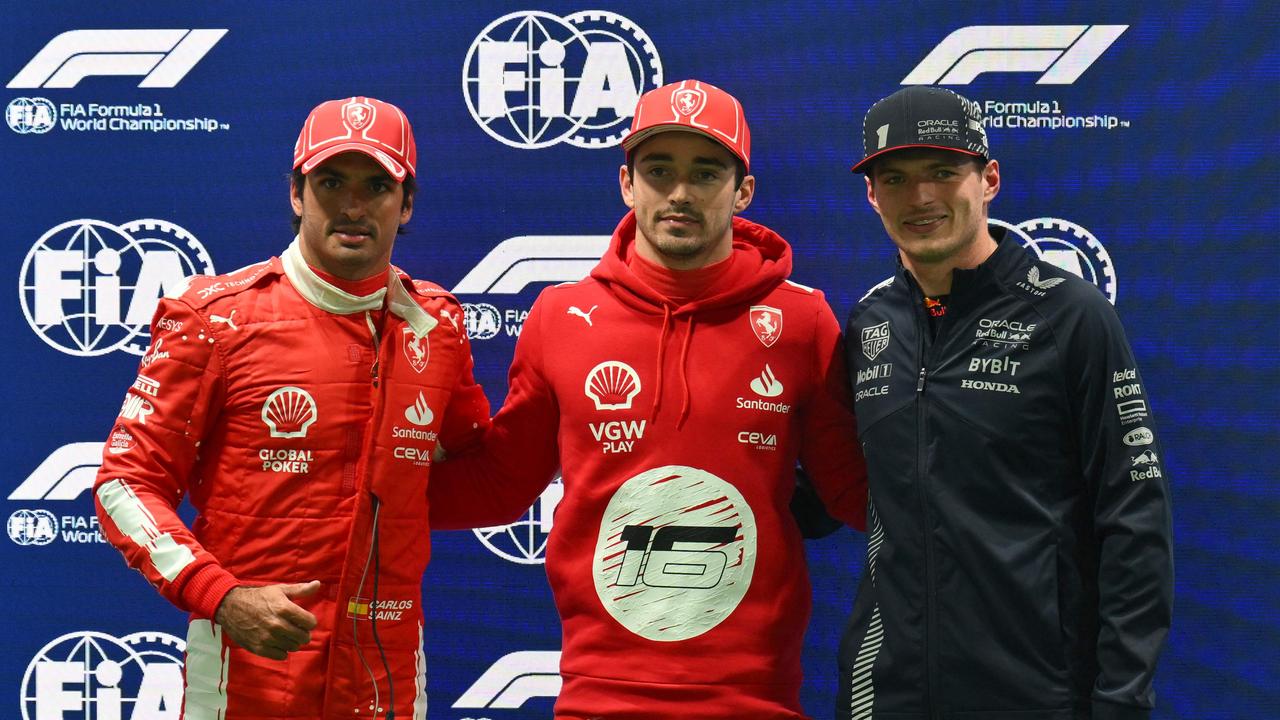Charles Leclerc celebrates after finishing in pole position with Carlos Sainz and Max Verstappen. Photo by ANGELA WEISS / AFP.