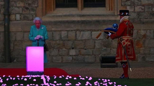 Britain's Queen Elizabeth II receives the Commonwealth Nations Globe before lighting the Principal Beacon. Picture: AFP.