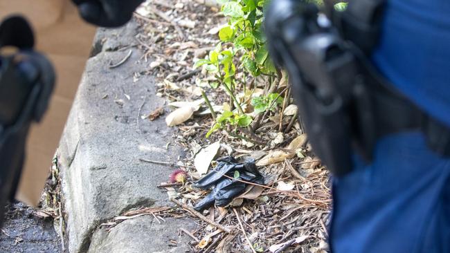 A rubber glove discovered by police and collected as evidence after a burnt out vehicle was found in Zetland following a gangland linked shooting in Bondi Junction. Liam Mendes / The Australian