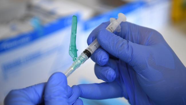 A pharmacist demonstrates the filling of syringes ahead of the COVID-19 vaccine. Picture: NCA NewsWire/Joel Carrett