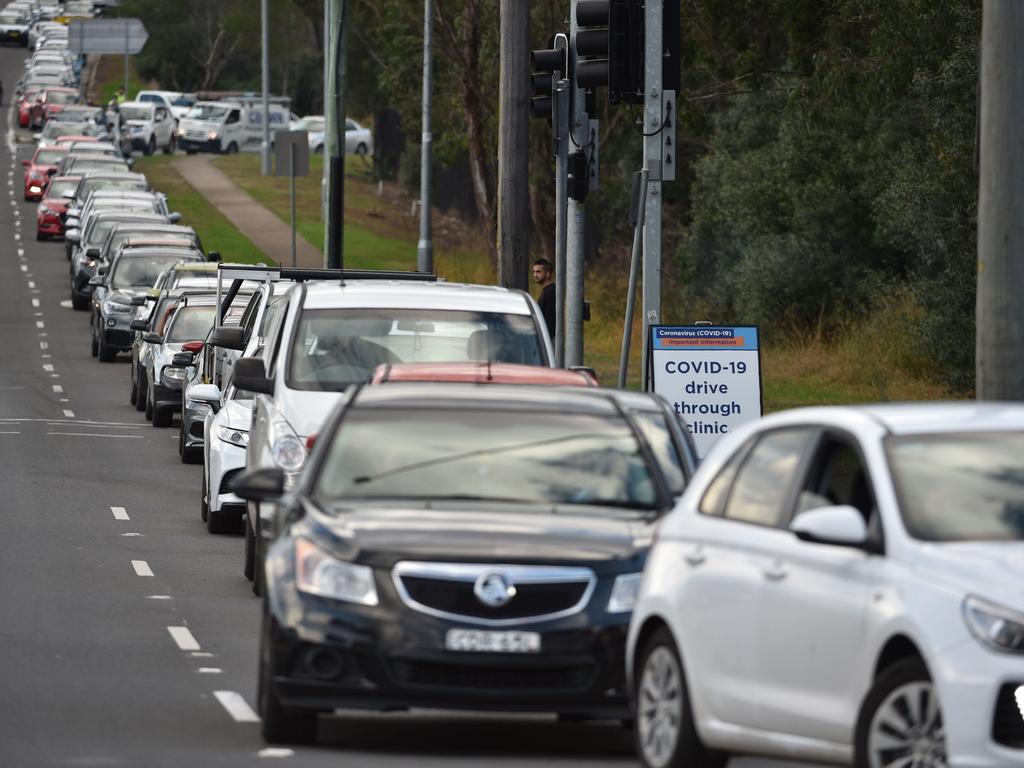 People queue up in their vehicles for a COVID-19 test at a testing station at the Crossroads Hotel. Picture: Peter Parks/AFP