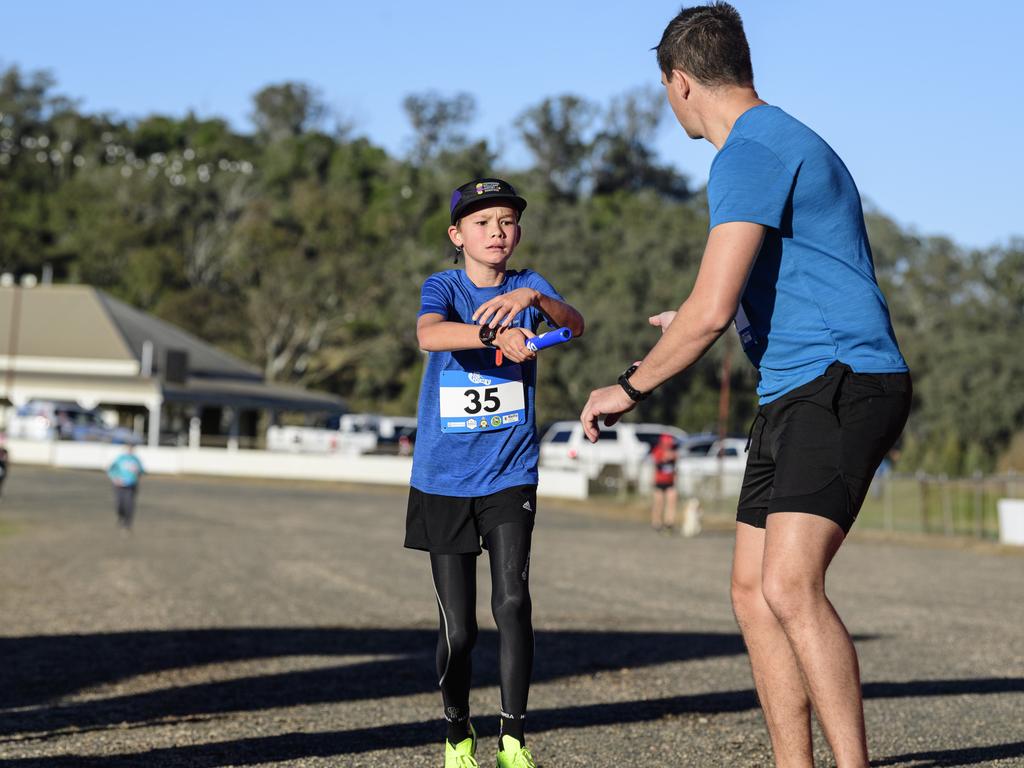 Charlie Colman hands the baton to dad Tylarr Colman for team Boomers in the 40 for Fortey relay at Toowoomba Showgrounds, Sunday, June 8, 2025. Picture: Kevin Farmer