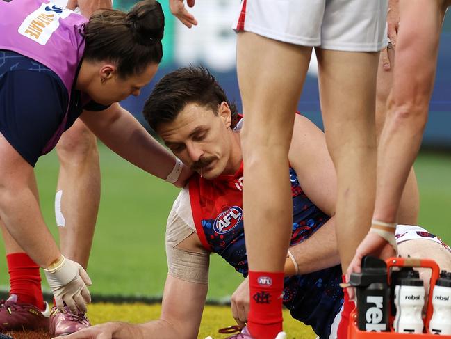 PERTH, AUSTRALIA - MAY 19: Jake Lever of the Demons is assisted off the field under concussion protocols during the 2024 AFL Round 10 match between Waalitj Marawar (West Coast Eagles) and Narrm (Melbourne Demons) at Optus Stadium on May 19, 2024 in Perth, Australia. (Photo by Will Russell/AFL Photos via Getty Images)