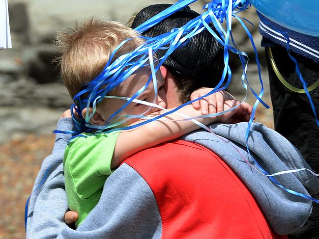 Missing fisherman Jesse Howes' two year old son Chaise is comforted by Jesse's brother Sam. Picture: Peter Lorimer