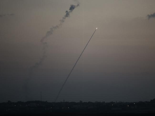 Diplomatic efforts to halt the bloodshed intensify as a rocket is launched from the Gaza strip into Israel, on Sunday. Picture: Menaem Kahana