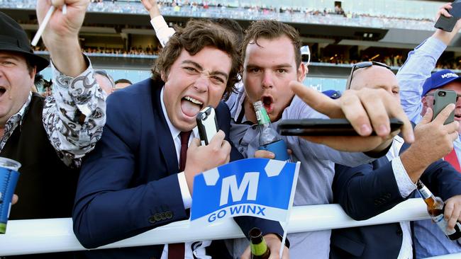 Spectators go crazy as champion mare Winx wins her 17th race in a row at Royal Randwick in Sydney for the Longines Queen Elizabeth Stakes day. Picture: Richard Dobson