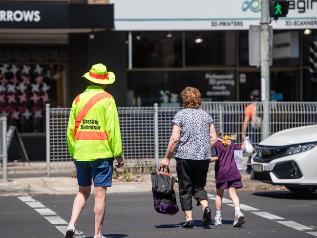 Crossing supervisor Peter helps people across the northbound lanes of Punt Rd. Picture: Jason Edwards