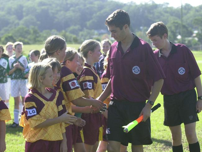 Linesman and referee shake hands with members of Kincumber’s girls team after their match following a regulation requiring players to shake hands with referees and linesmen after matches on Central Coast in 2003. Pic: Gary Graham.