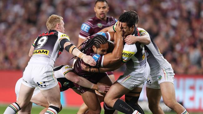 Martin Taupau is tackled during the bizarre finals clash which had a bit of everything.