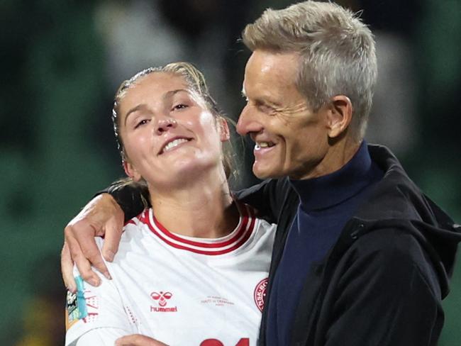 Denmark's coach Lars Sondergaard (R) celebrates with Denmark's forward #21 Mille Gejl (2R) and players at the end of the Australia and New Zealand 2023 Women's World Cup Group D football match between Haiti and Denmark at Perth Rectangular Stadium in Perth on August 1, 2023. (Photo by Colin MURTY / AFP)