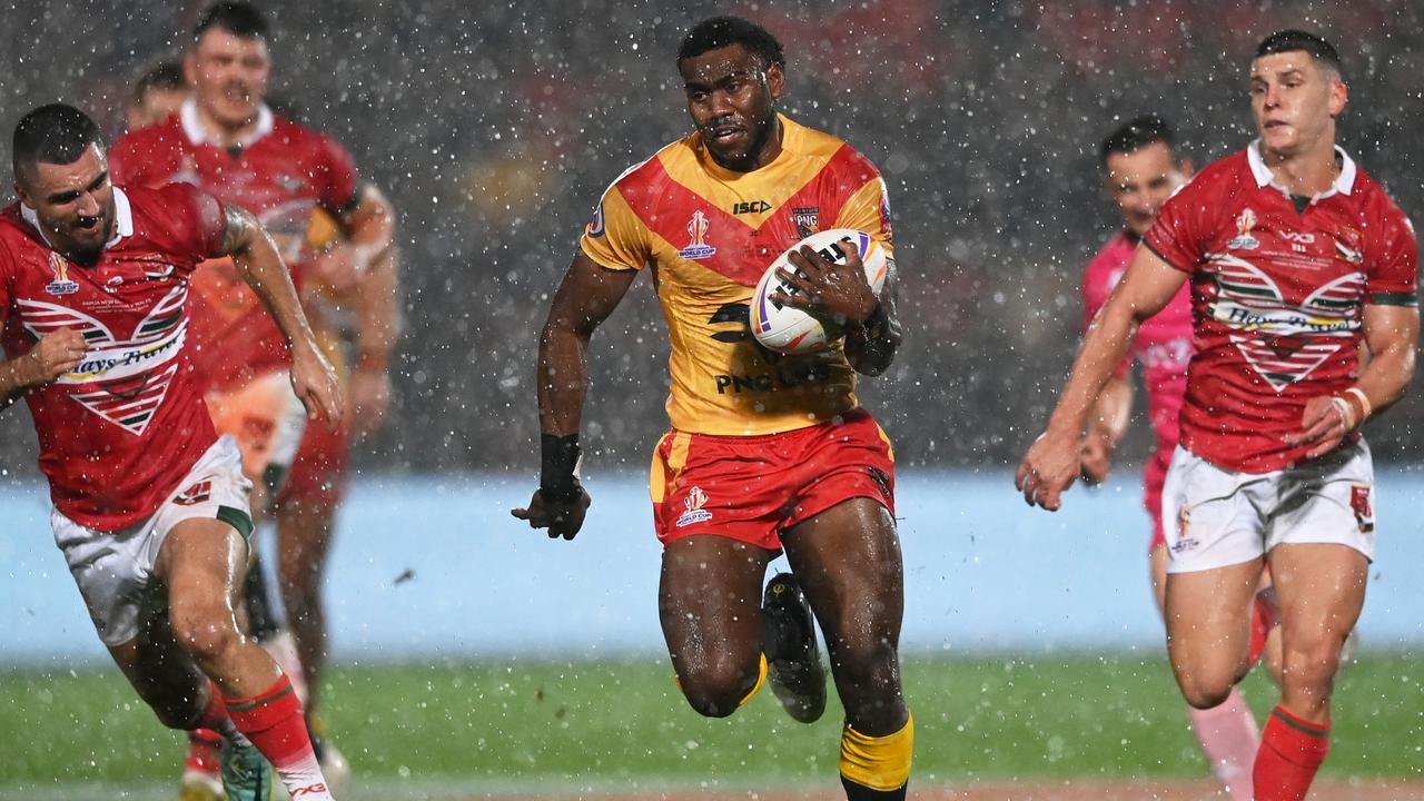 DONCASTER, ENGLAND - OCTOBER 31: Jimmy Ngutlik of Papua New Guinea runs in to score their sides third try during the Rugby League World Cup 2021 Pool D match between Papua New Guinea and Wales at the Keepmoat Stadium on October 31, 2022 in Doncaster, England. (Photo by Gareth Copley/Getty Images)