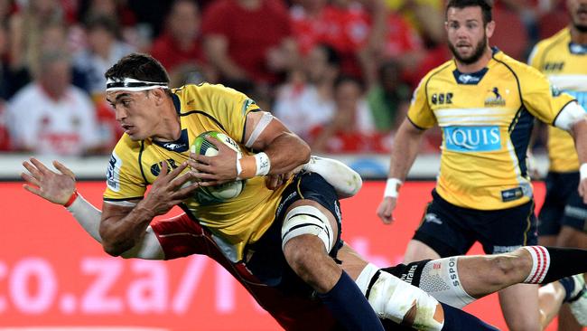 Rory Arnold of the Brumbies is tackled during against the Lions.