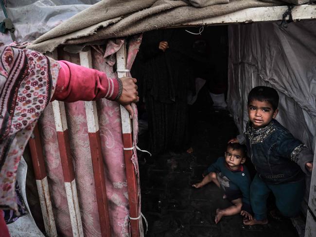 Displaced Palestinian children wait inside their makeshift tents at a camp in Rafah amid warnings of looming famine. Malnutrition was “non-existent” in the territory before the war. Picture: AFP