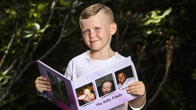 Kyden and his precious family book. Picture: Nigel Hallett