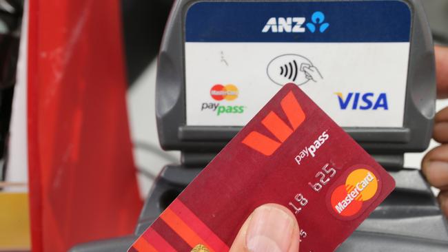 Stock image of a customer using a tap-and-go credit card in a store. (AAP Image/David Crosling) NO ARCHIVING